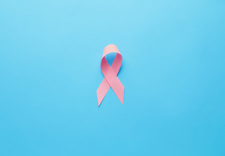 Pink ribbon on color background. Breast cancer awareness conceptの写真素材