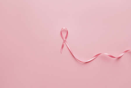 Pink ribbon on color background. Breast cancer awareness conceptの写真素材