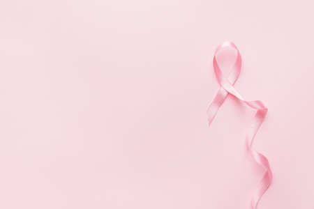 Pink ribbon on color background. Breast cancer awareness conceptの写真素材