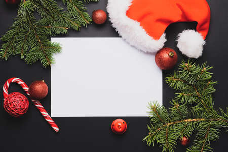 Blank paper for letter to Santa and Christmas decor on dark background