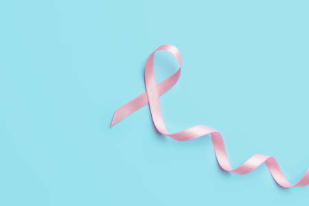 Pink ribbon on color background. Breast cancer awareness conceptの写真素材