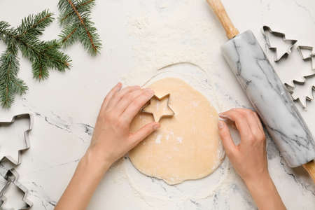 Woman preparing Christmas bakery on table, top viewの写真素材