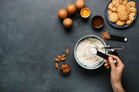Woman preparing bakery on table, top view