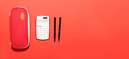 School stationery and calculator on color background with space for textの写真素材