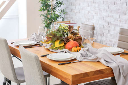 Beautiful table setting for Thanksgiving Day celebration in dining roomの写真素材