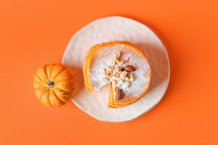 Plate with tasty pumpkin pancakes on color backgroundの写真素材