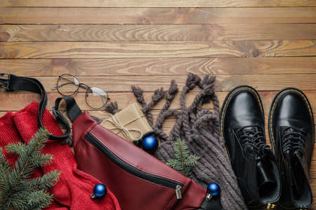 Christmas composition with stylish clothes and accessories on wooden backgroundの写真素材