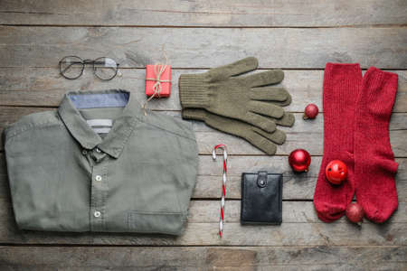 Christmas composition with stylish clothes and accessories on wooden backgroundの写真素材