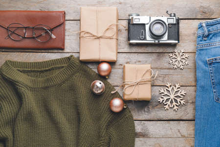 Christmas composition with stylish clothes and accessories on wooden backgroundの写真素材