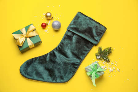 Composition with Christmas sock on color background
