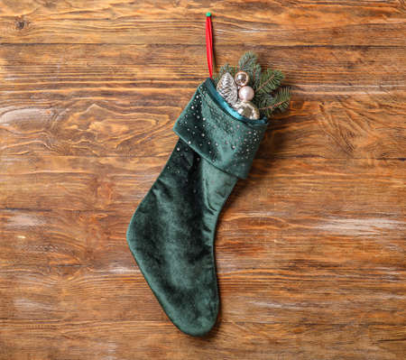 Christmas sock with decor on wooden background