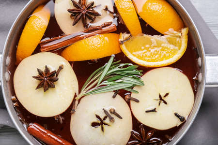 Saucepan with hot mulled wine on table, closeupの写真素材