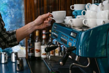 Barista making hot coffee in cafeの写真素材