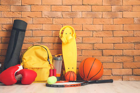 Set of sport equipment on floor near brick wallの写真素材