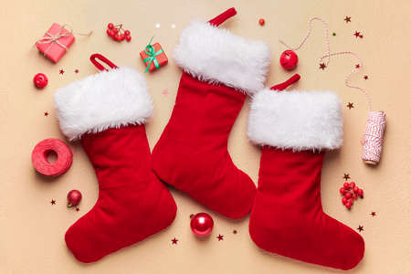 Composition with Christmas socks on color background