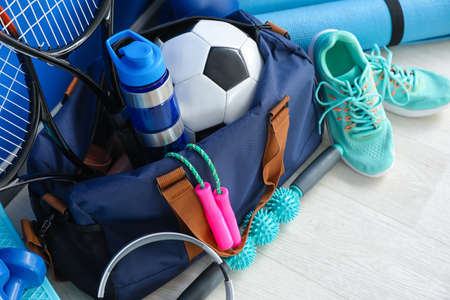 Set of sport equipment on floor near color wallの写真素材