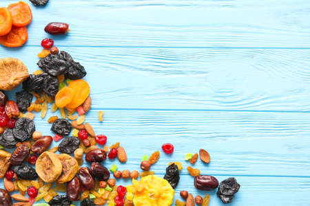 Different dried fruits and nuts on color wooden backgroundの写真素材