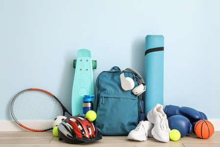 Set of sport equipment on floor near color wallの写真素材