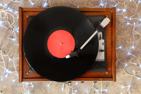 Record player and Christmas decor on gray background
