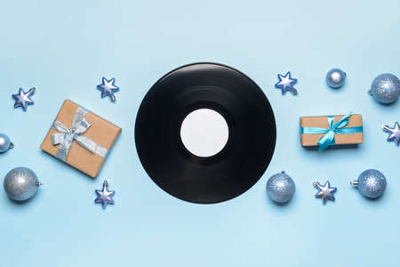 Vinyl disk and Christmas decor on color backgroundの写真素材