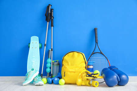 Set of sport equipment on floor near color wall