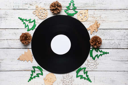 Vinyl disk and Christmas decor on wooden backgroundの写真素材