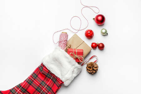 Composition with Christmas sock on white background
