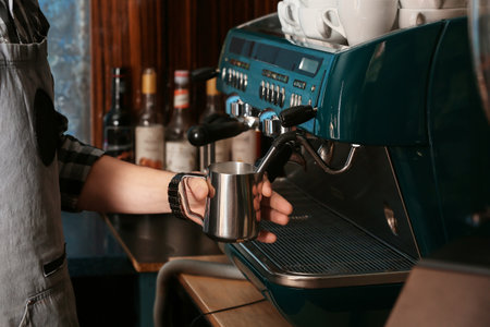 Barista making hot coffee in cafeの写真素材
