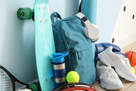 Set of sport equipment on floor near color wallの写真素材