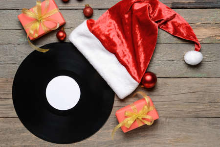 Vinyl disk and Christmas decor on wooden backgroundの写真素材