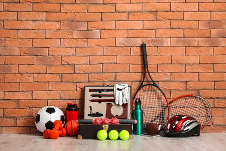 Set of sport equipment on floor near brick wallの写真素材