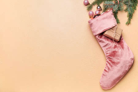 Composition with Christmas sock on color background