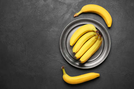 Tray with ripe bananas on dark backgroundの写真素材
