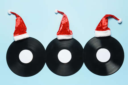 Vinyl disks and Santa hats on color backgroundの写真素材