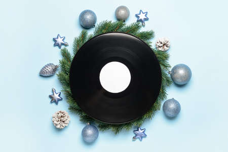 Vinyl disk and Christmas decor on color backgroundの写真素材