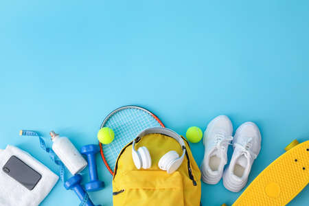 Set of sport equipment with backpack on color backgroundの写真素材