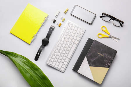 Composition with modern smart watch, computer keyboard and mobile phone on light backgroundの写真素材