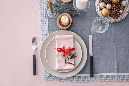 Beautiful table setting with Christmas decor in living roomの写真素材
