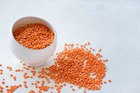 Bowl with raw lentils on light table