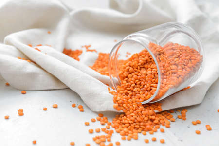 Jar with raw lentils on tableの写真素材