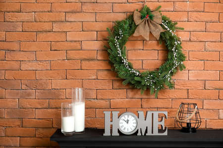 Beautiful fireplace with Christmas wreath in interior of room
