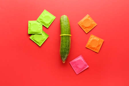 Cucumber with condoms on color background. Erotic conceptの写真素材