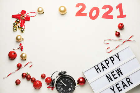 New Year composition with alarm clock and figure 2021 on white background