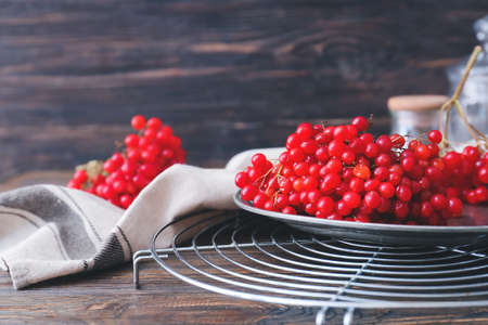 Plate with fresh viburnum berries on table, closeupの写真素材