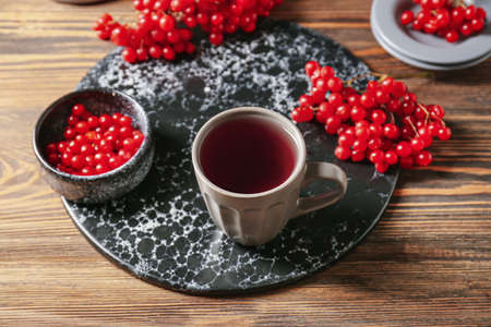 Cup of healthy viburnum tea on tableの写真素材