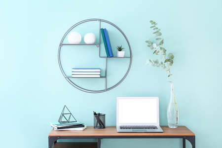 Stylish workplace with modern laptop against color wall in roomの写真素材