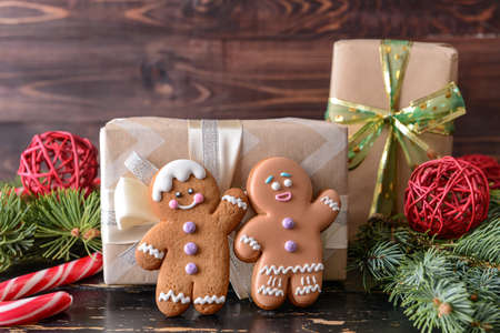 Christmas composition with gingerbread cookies and gifts on wooden background