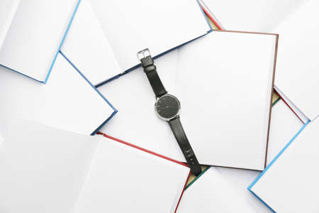 Wrist watch on open booksの写真素材