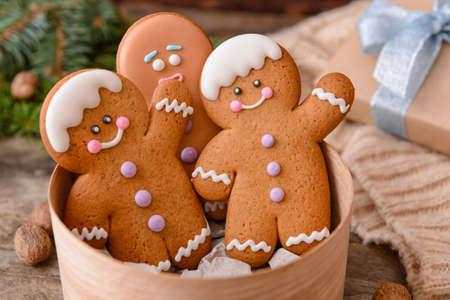 Box with tasty gingerbread cookies on tableの写真素材