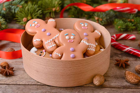 Box with tasty gingerbread cookies on tableの写真素材